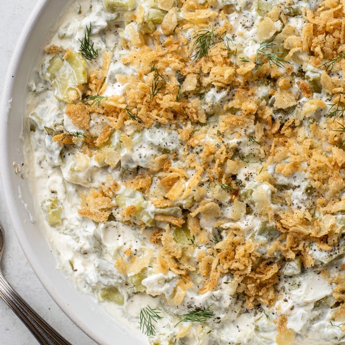 Close-up of Fried Pickle Dip, a tangy appetizer with salty, crunchy panko topping.
