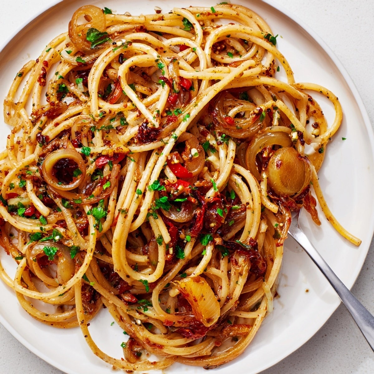 Golden Caramelized Shallot Pasta glistens; a vegetarian Italian-inspired dinner, ready to be served.