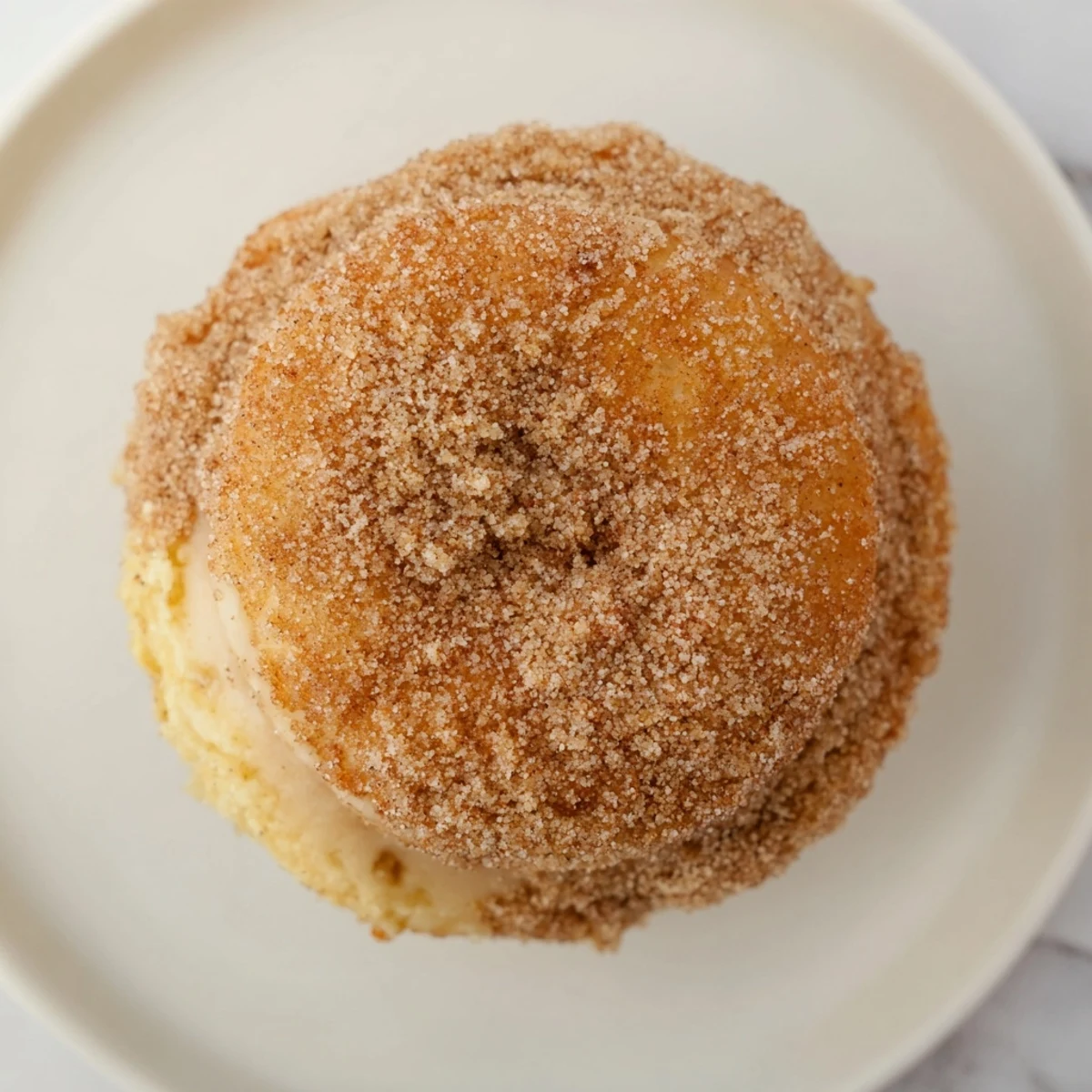 Warm, golden Baked Apple Cider Donuts glistening with cinnamon sugar, perfect for enjoying this autumn.