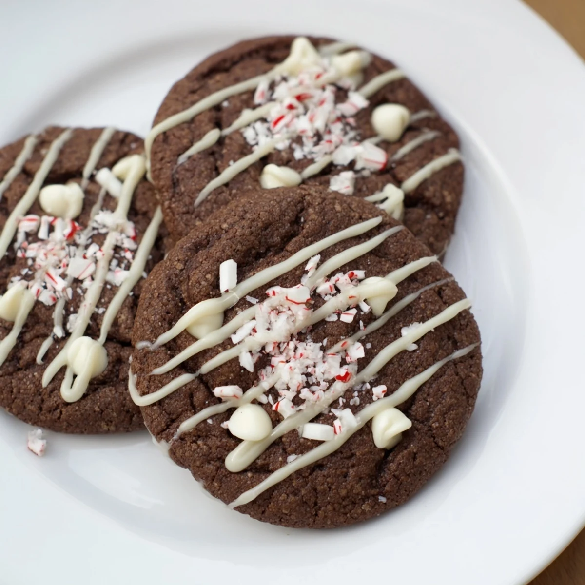 Warm Peppermint Mocha Cookies, dripped with white chocolate and sprinkled with crushed candy canes, ready to eat.