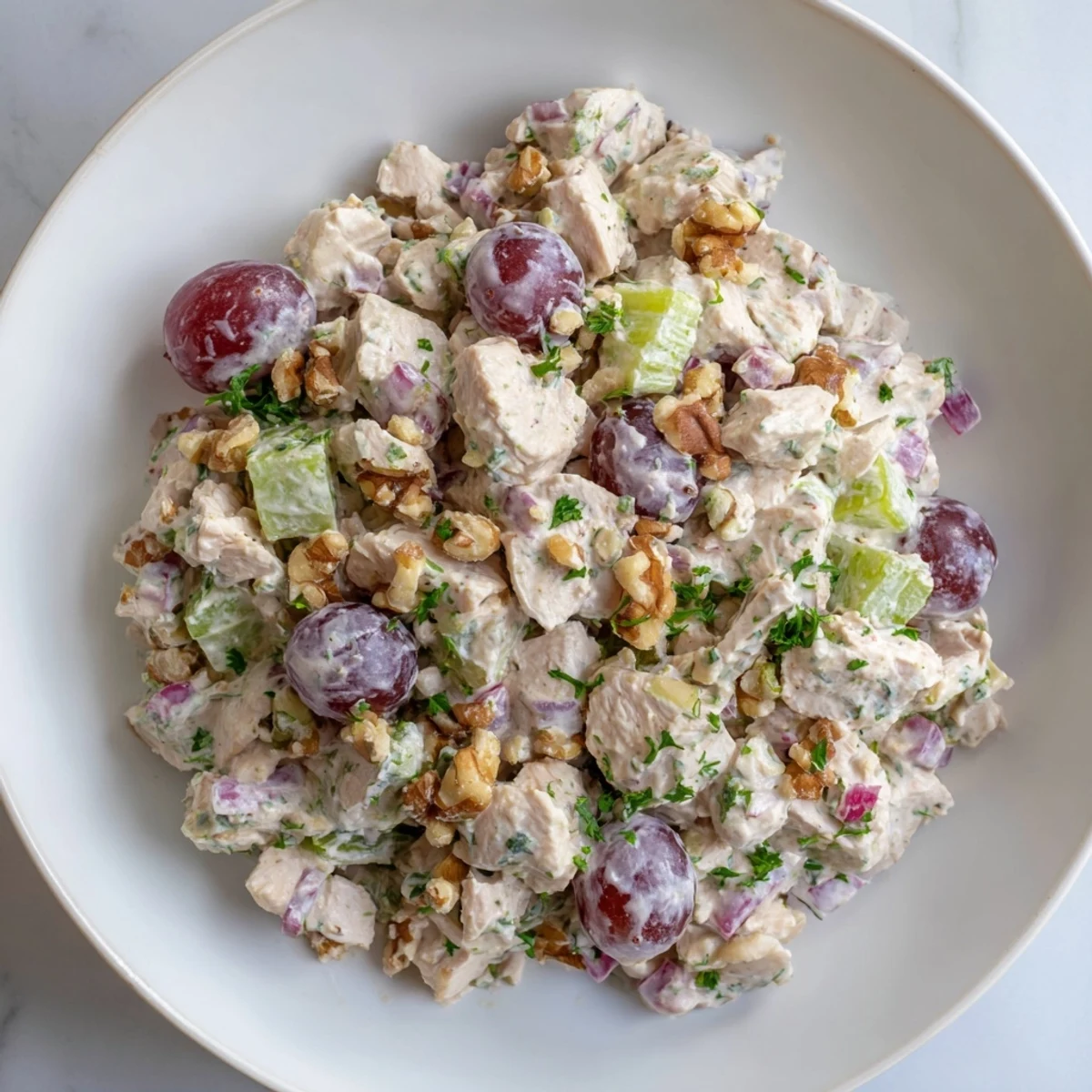 Lemony, creamy chicken salad, studded with red onion, is perfect beside crackers for a simple meal.