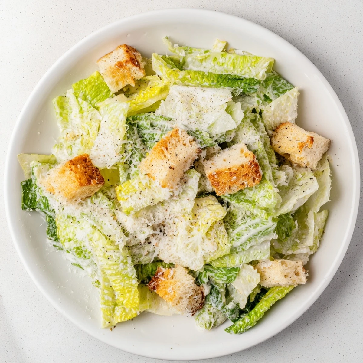 Crisp romaine and crunchy croutons dominate this delicious Caesar salad, generously dressed and ready.