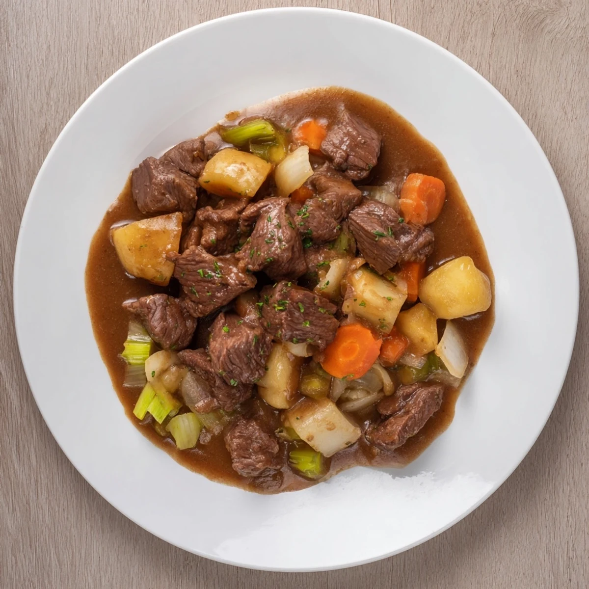 Flavorful, rustic beef casserole bubbling in a Dutch oven with the aroma of herbs and tender meat.