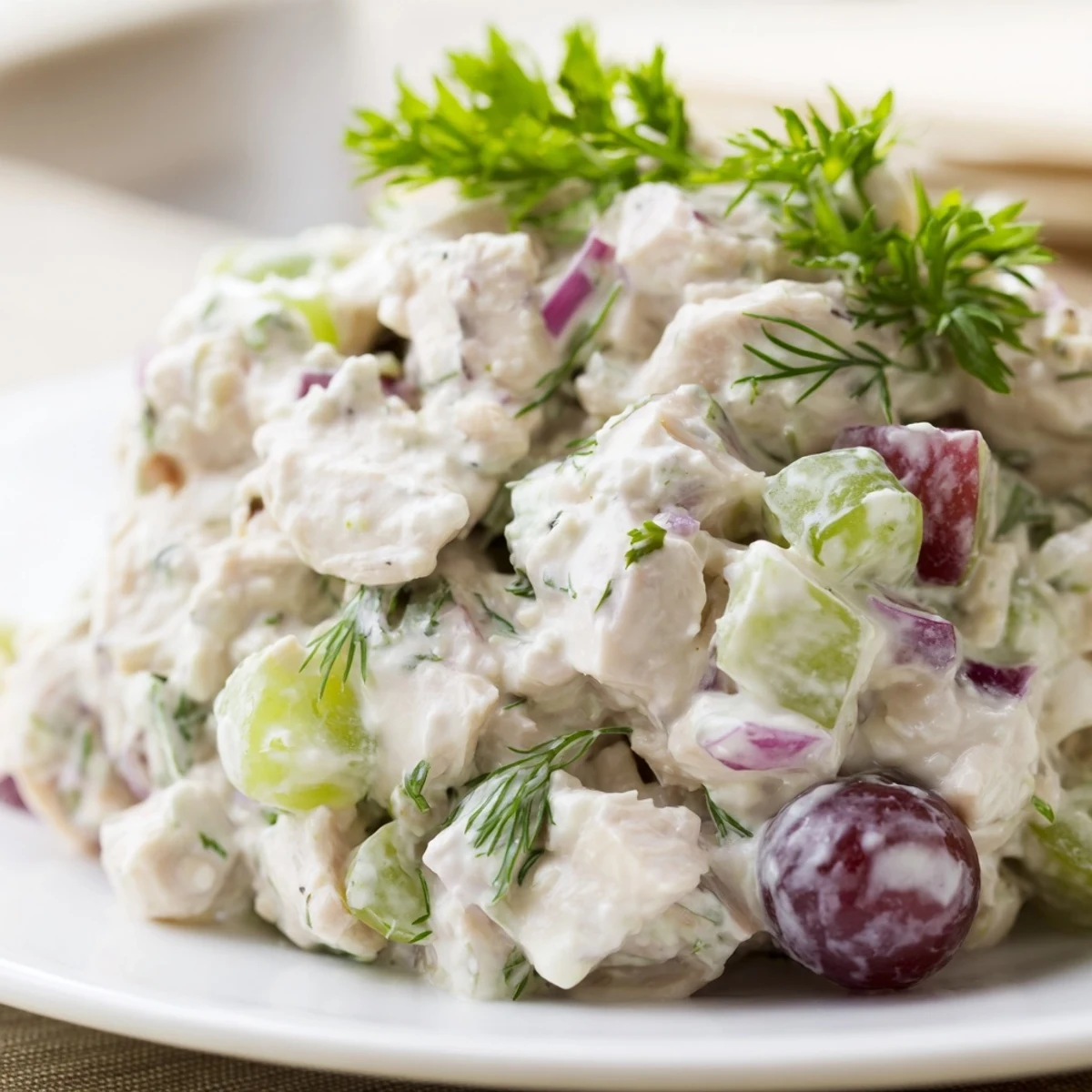 Gluten-free Chicken Salad Scoop with red onion and grapes, ready to eat with crackers.