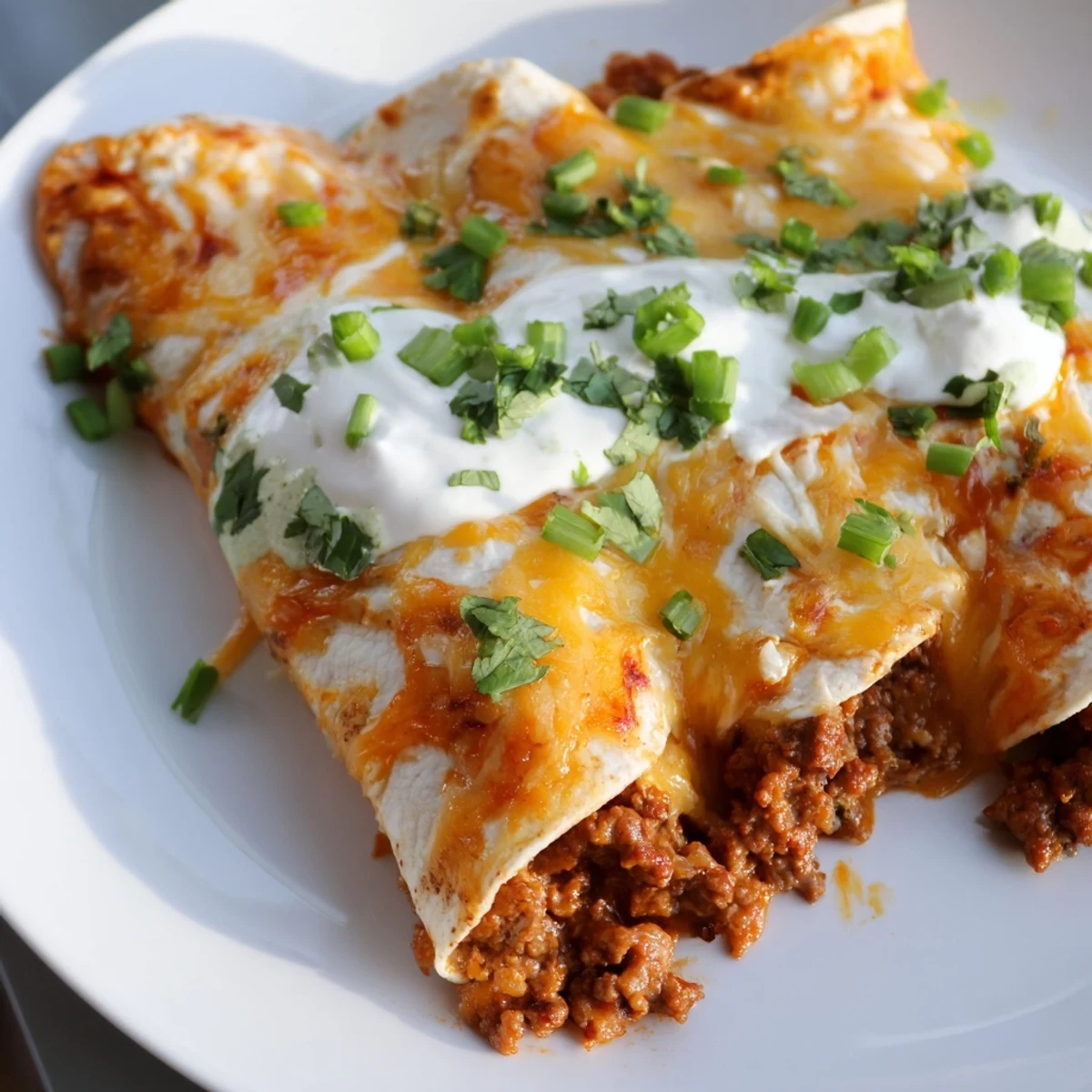 Golden baked Beef Enchiladas with Green Sauce served with melted cheese, ready for a comforting Tex-Mex dinner.