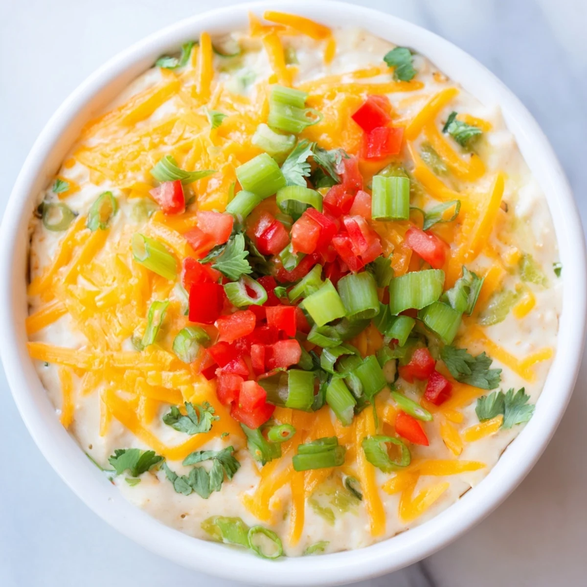Championship Bean Dip fresh from the oven, topped with sliced green onions and melted cheese.