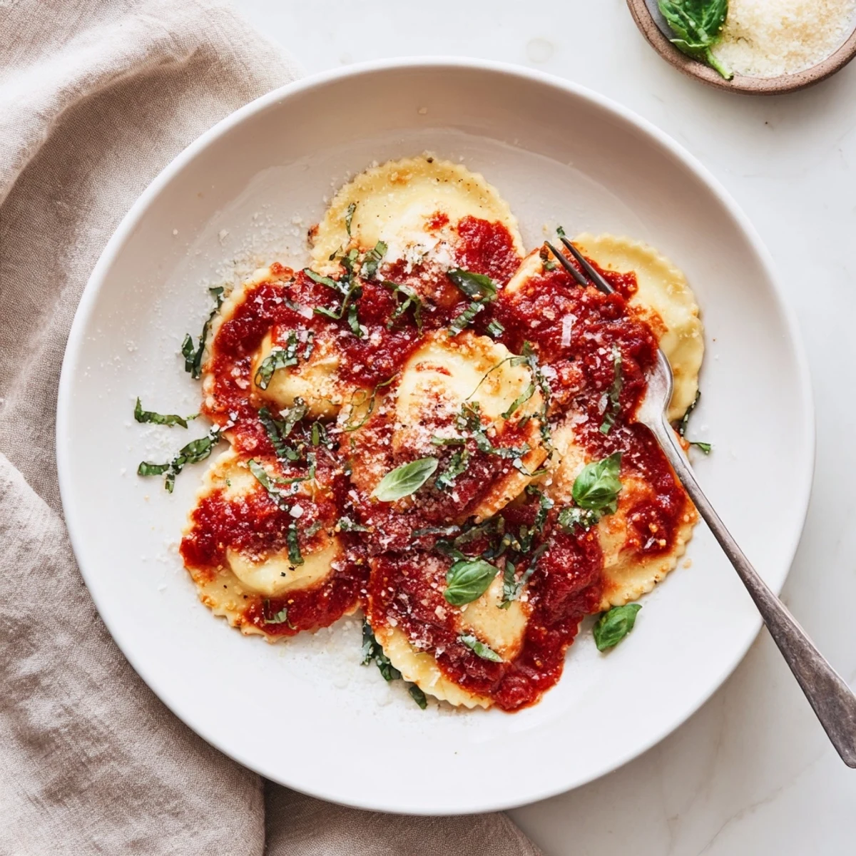 Golden-brown cheese ravioli tossed in a vibrant tomato basil sauce with fresh grated Parmesan.  
