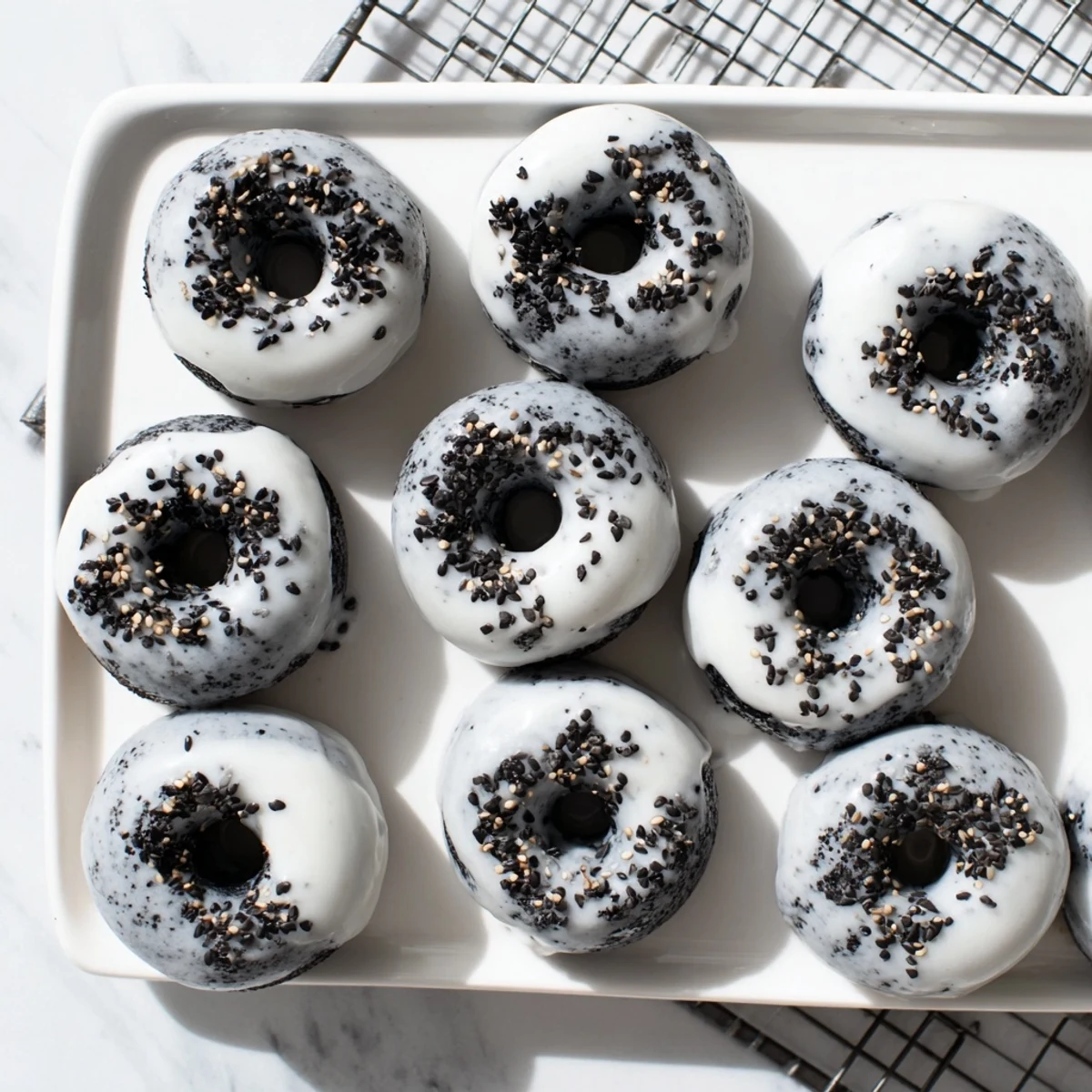 Close-up of one Black Sesame Mochi Donut with a nutty black sesame glaze, ready to be enjoyed.