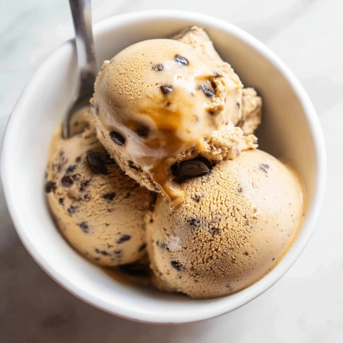 Rich Vietnamese Coffee Ice Cream served in a waffle cone with a bold espresso shot drizzled over the top.