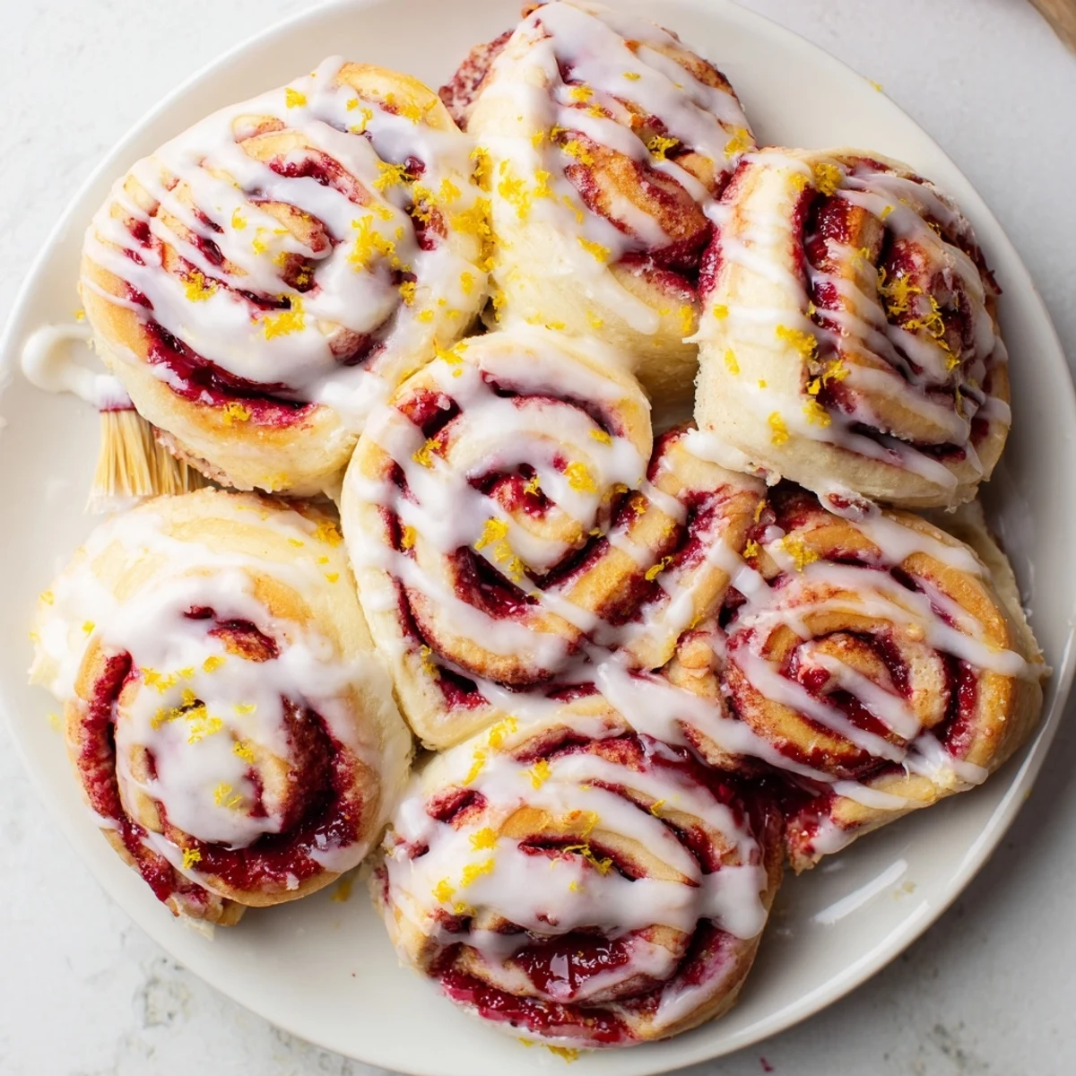 Homemade Raspberry Cinnamon Rolls with Lemon Glaze, golden brown and soft, ready to serve for a cozy breakfast.