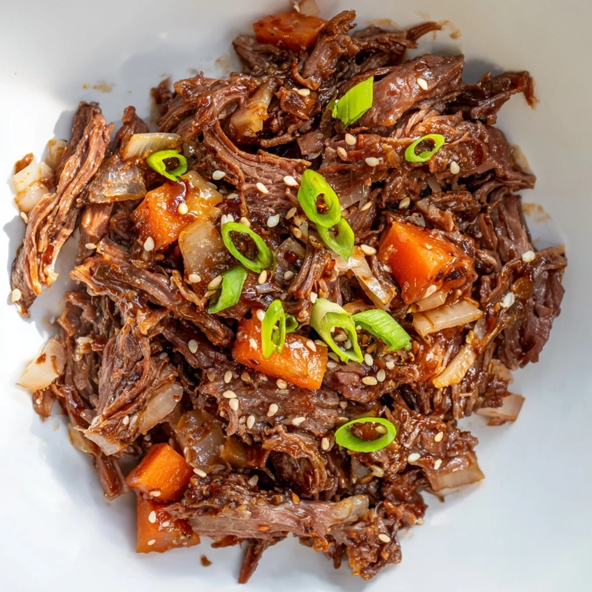 Korean Style Pot Roast in a Dutch oven, tender shredded beef with carrots and daikon in glossy sauce.