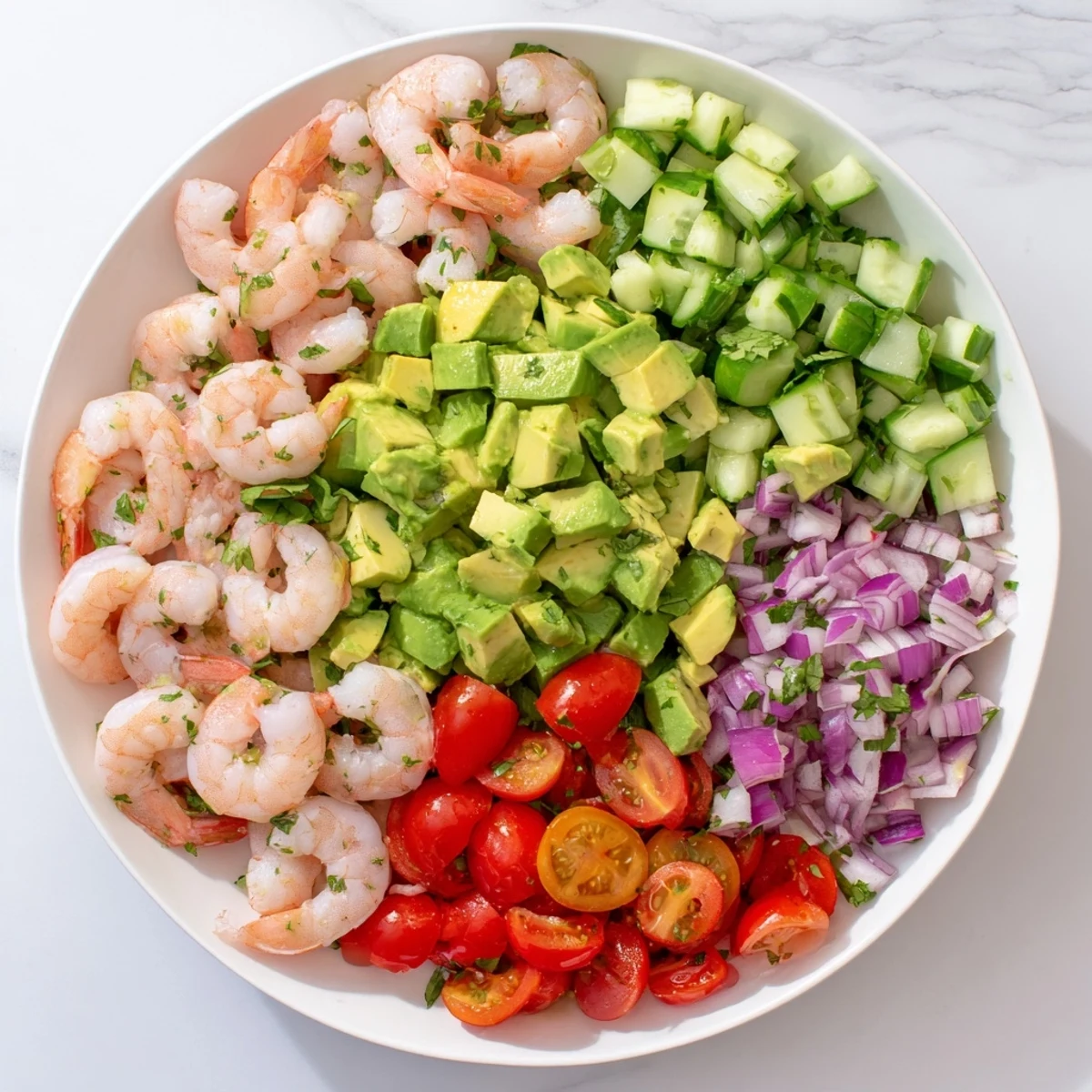 Succulent grilled shrimp and creamy avocado cubes in Healthy Shrimp Avocado Salad, with crisp cucumber and zesty lime dressing.