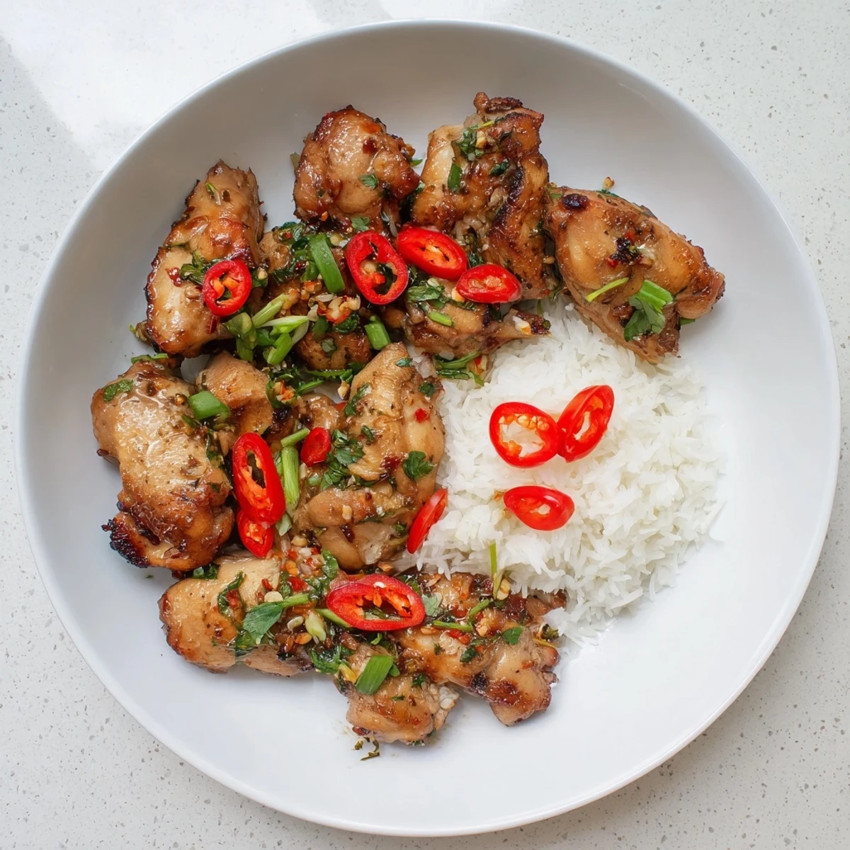 Golden pan-seared Vietnamese Lemongrass Chicken garnished with scallions, ready to serve hot