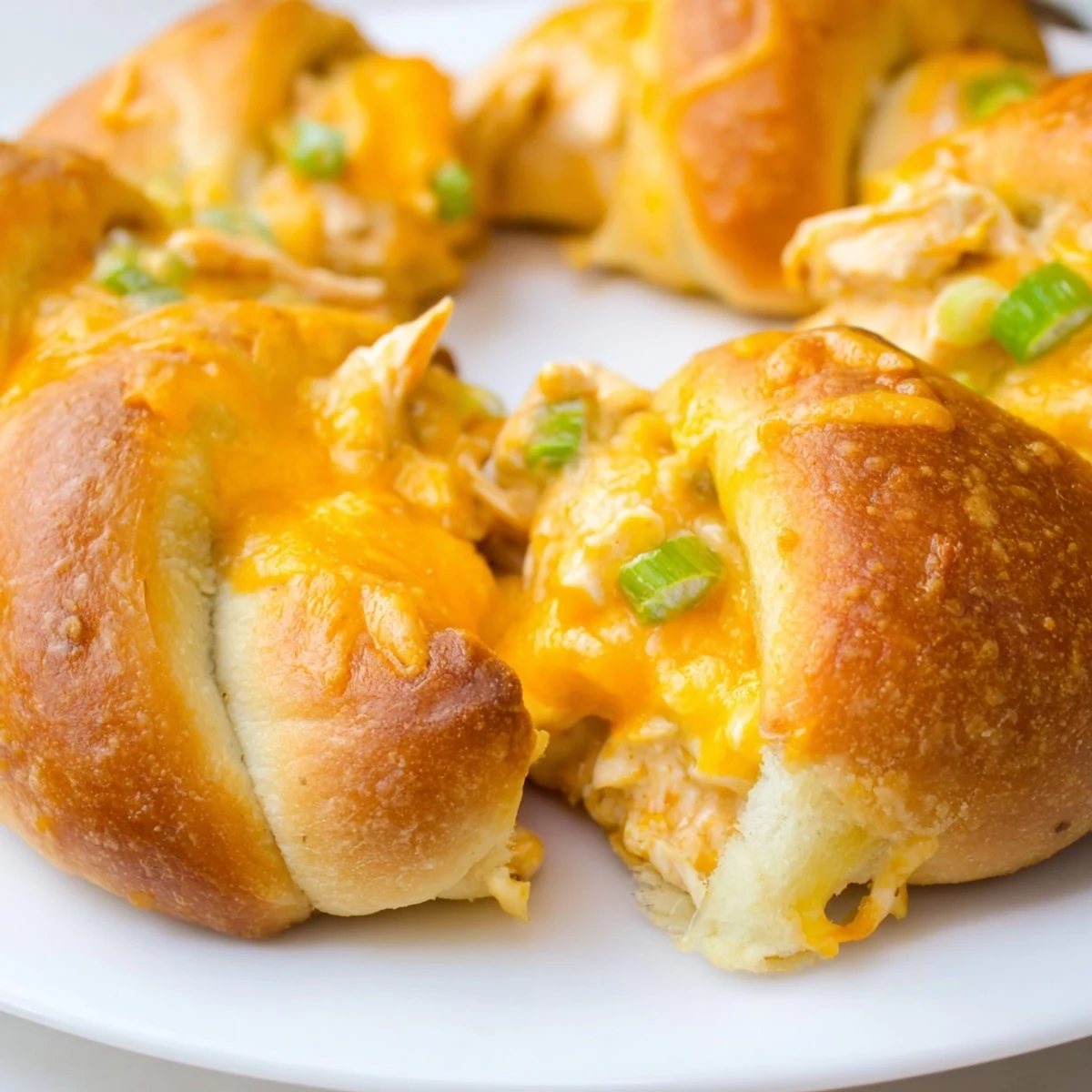 Flaky crescent rolls stuffed with creamy shredded chicken mixture baked until golden and topped with melted mozzarella cheese