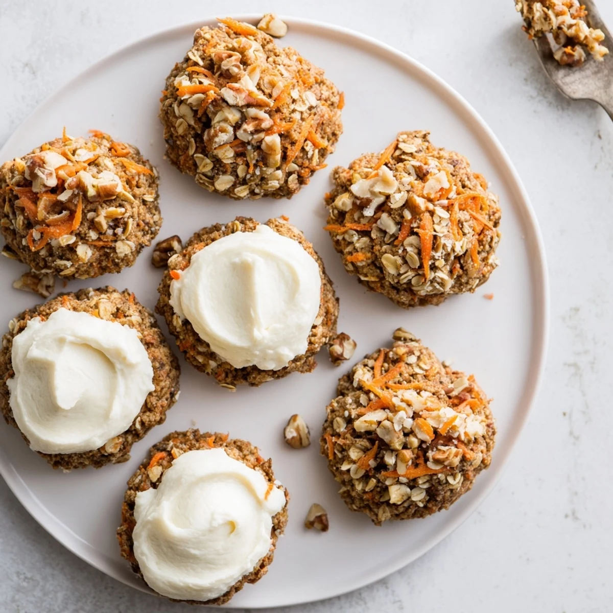 Golden spiced carrot cake cookies with visible grated carrot bits and nuts