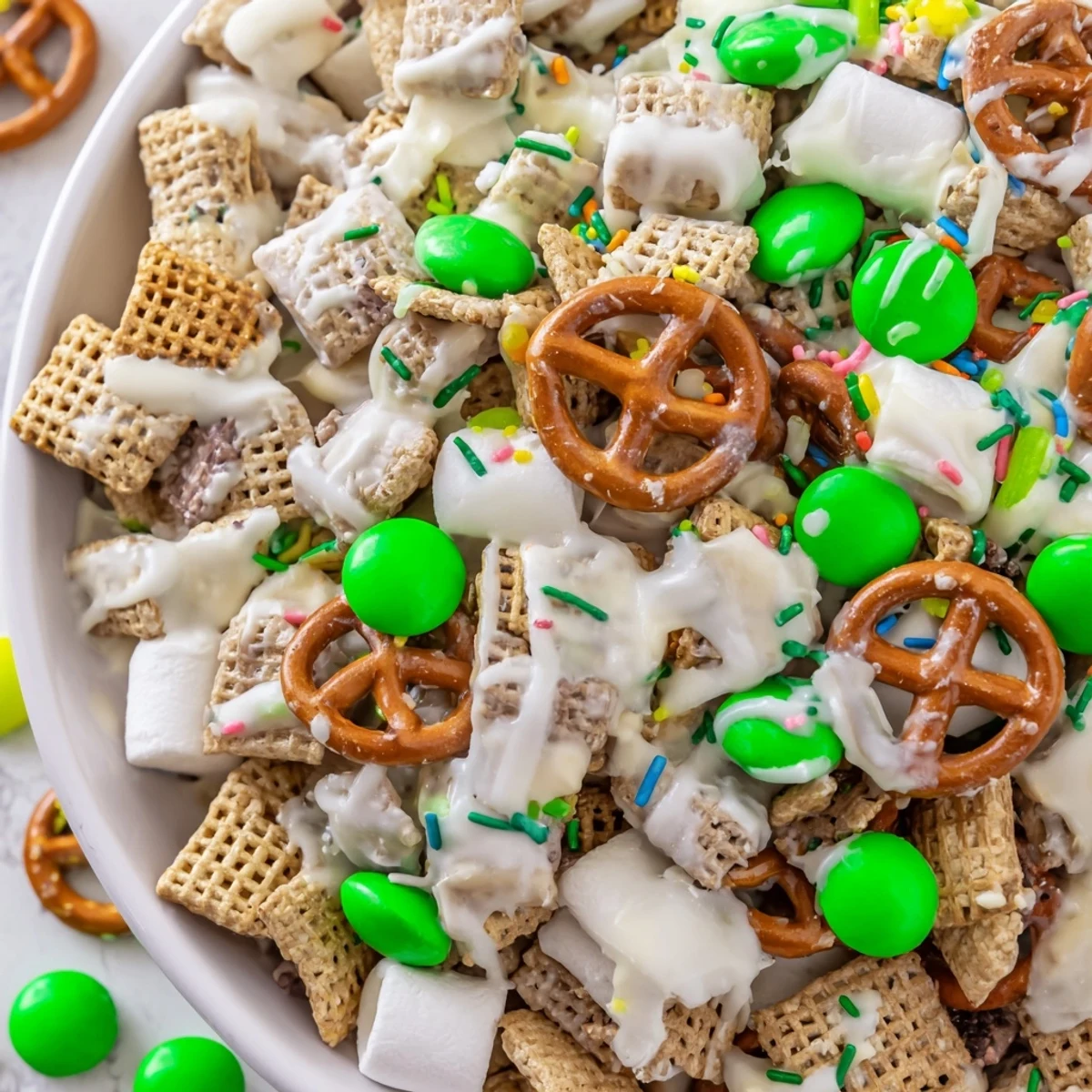 Colorful Leprechaun Bait snack mix with white chocolate coating and green candies