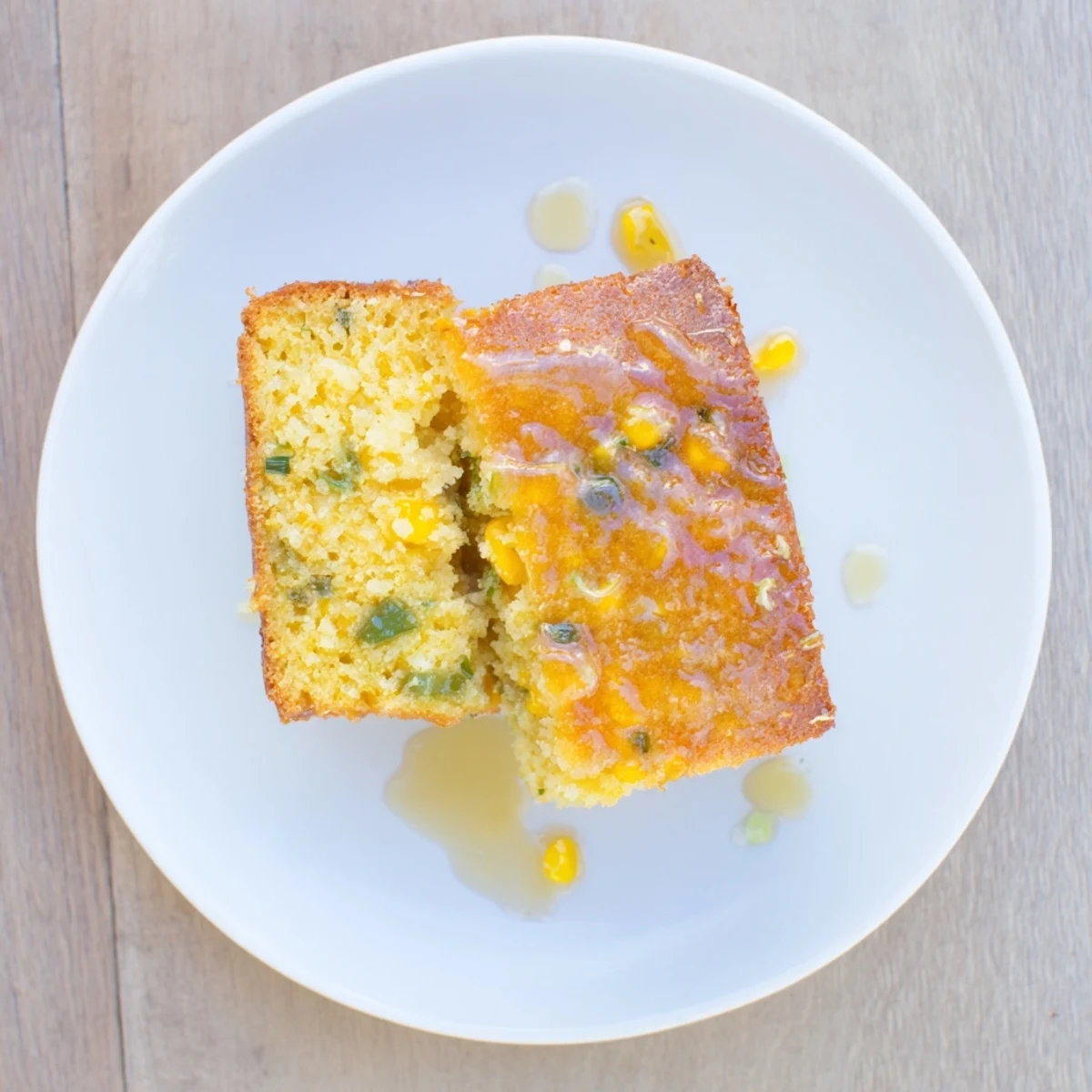 Warm square of moist cornbread topped with sweet lime glaze and fresh chopped jalapeño peppers