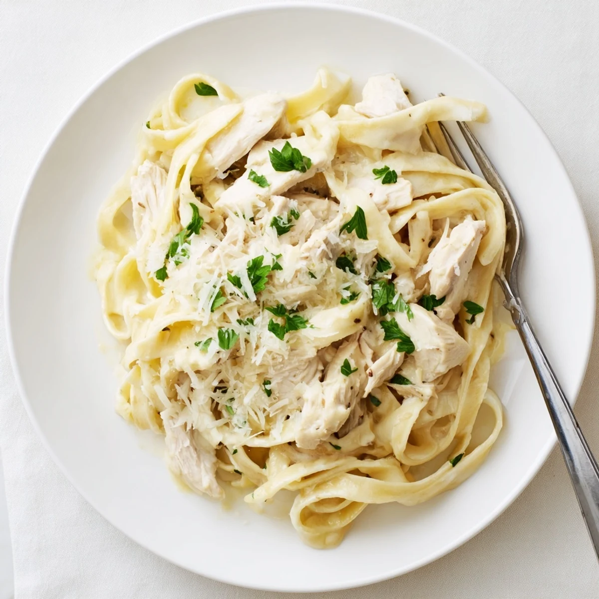 Creamy Crock Pot Chicken Alfredo with tender shredded chicken and al dente fettuccine in a rich Parmesan sauce
