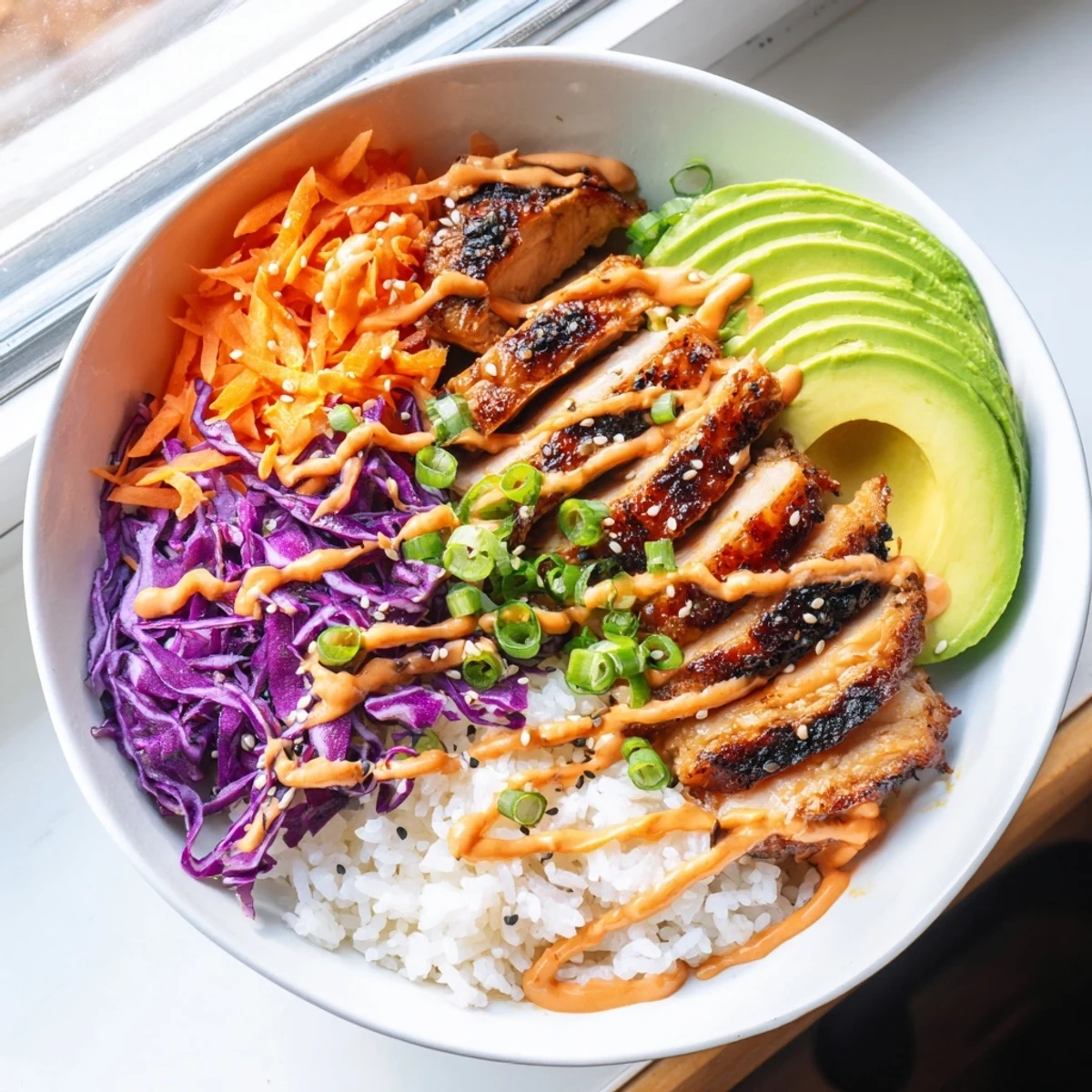 Sizzling grilled Korean BBQ chicken sliced over fluffy white rice with colorful shredded vegetables and creamy gochujang mayo drizzle
