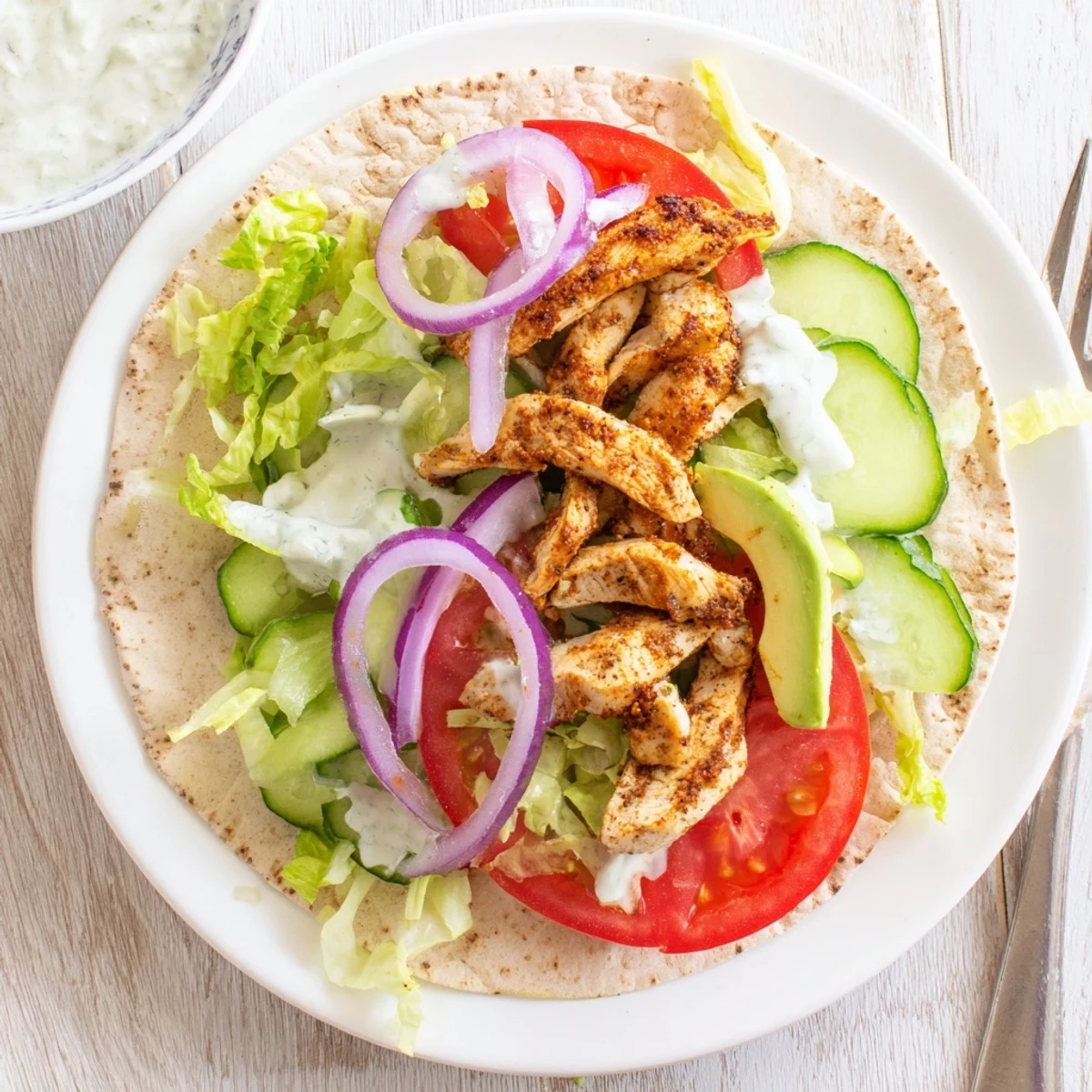 Protein packed wrap featuring crispy cottage cheese flatbread filled with tender chicken strips and colorful garden veggies