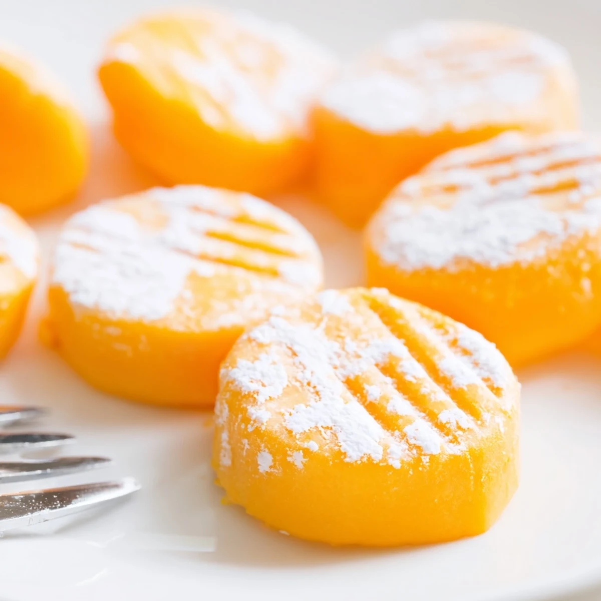 Vibrant orange cream cheese mints chilled and ready for holiday dessert trays and weddings