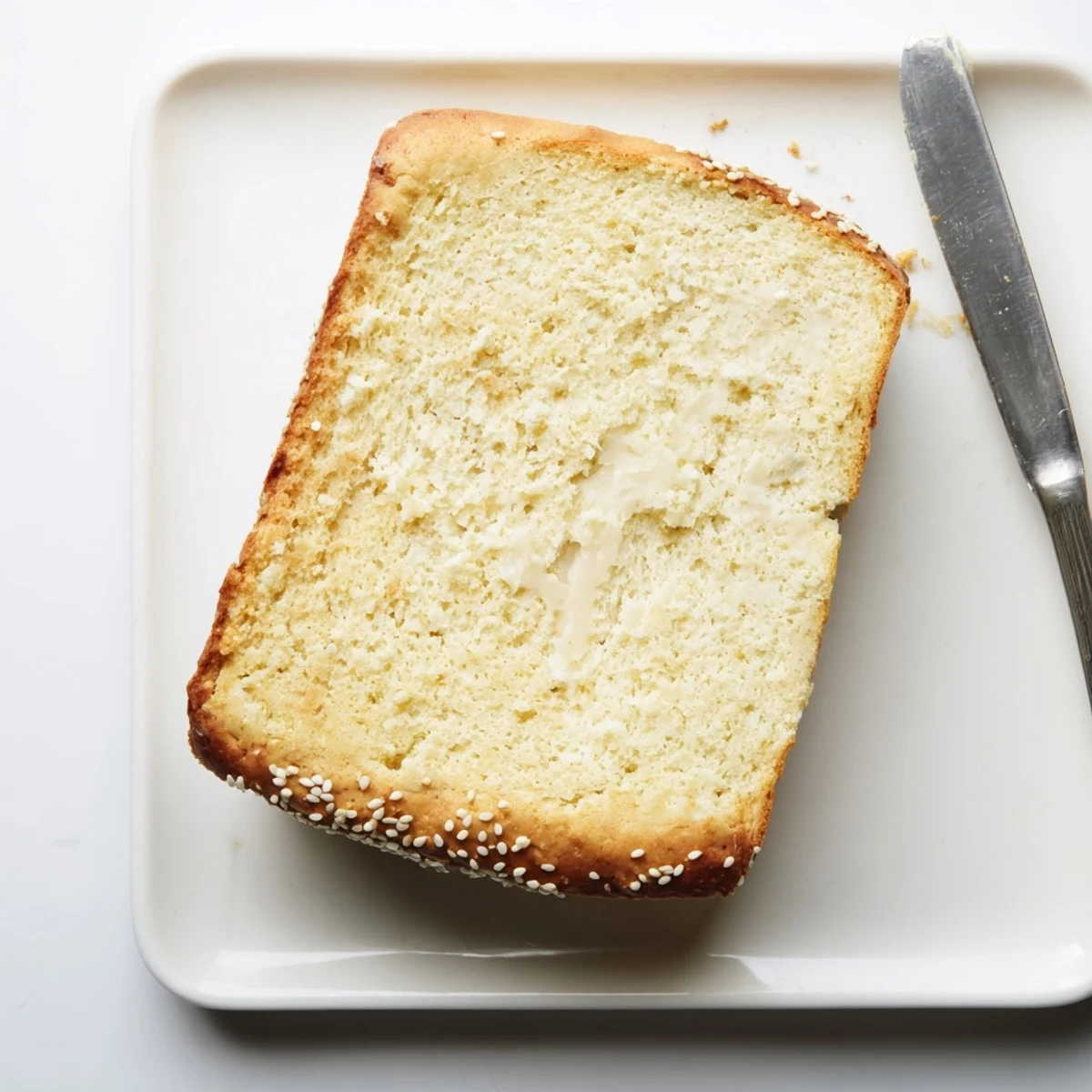 Fluffy low carb zero carb yogurt bread toast topped with melting butter and fresh herbs