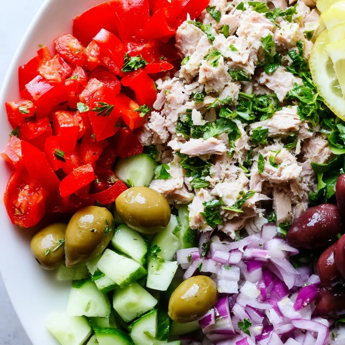 Crisp vegetables and flaked tuna tossed in bright lemon herb dressing over leafy greens