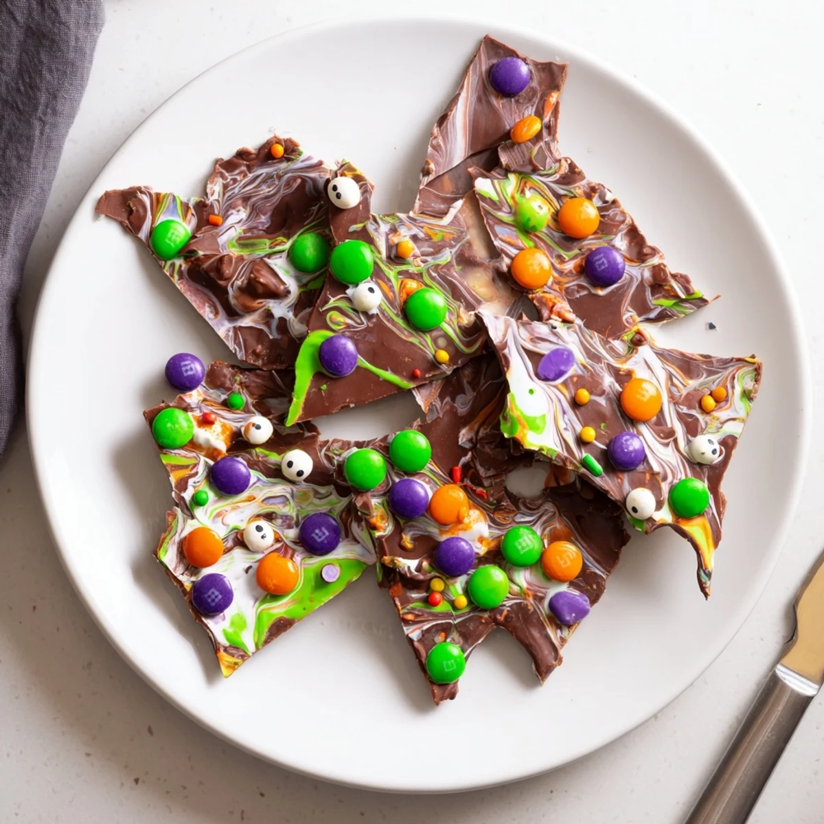 Dark and white chocolate Melting Witches Bark studded with Halloween candies
