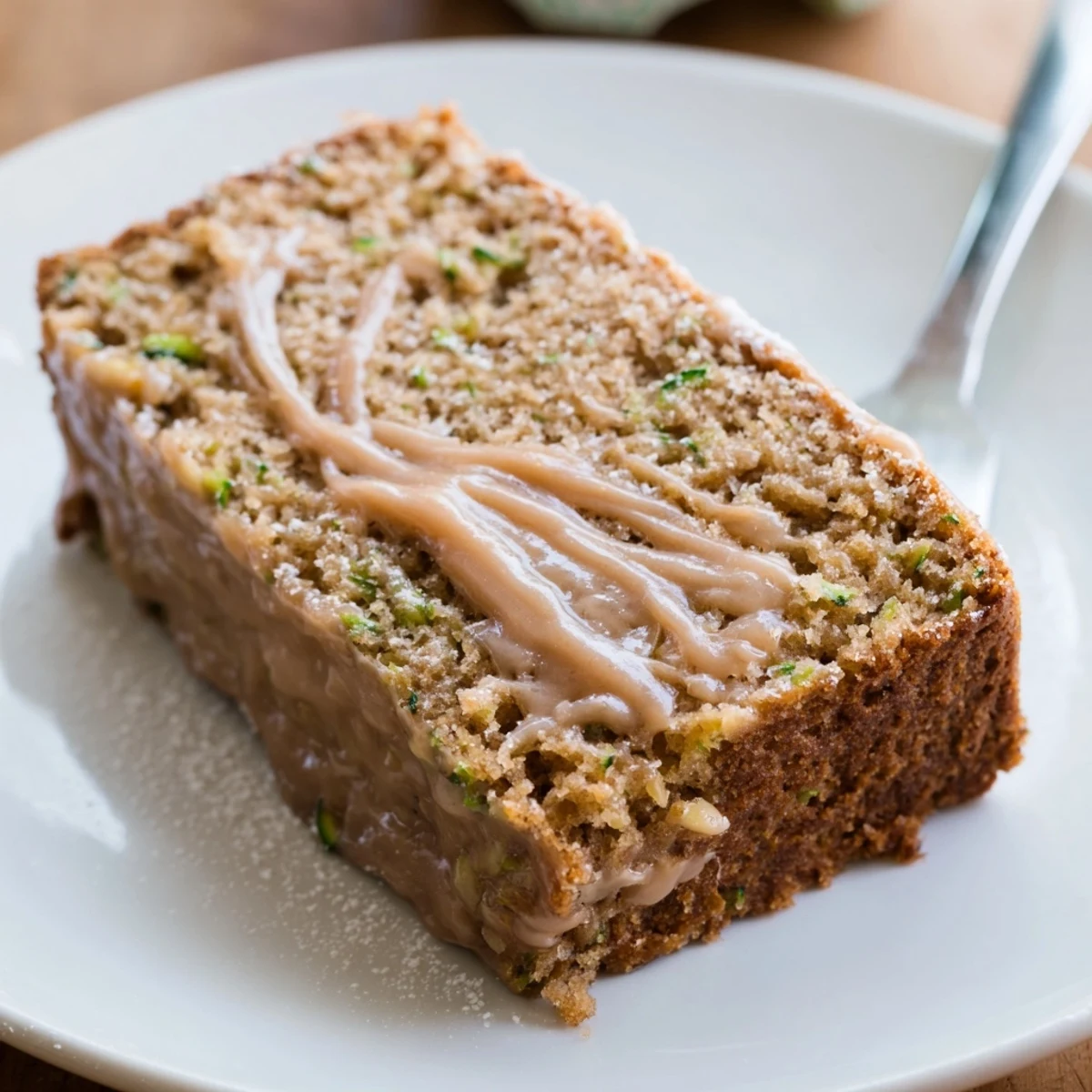 Whole Zucchini Cake With Brown Sugar Icing on wire rack, cooling, speckled with nuts