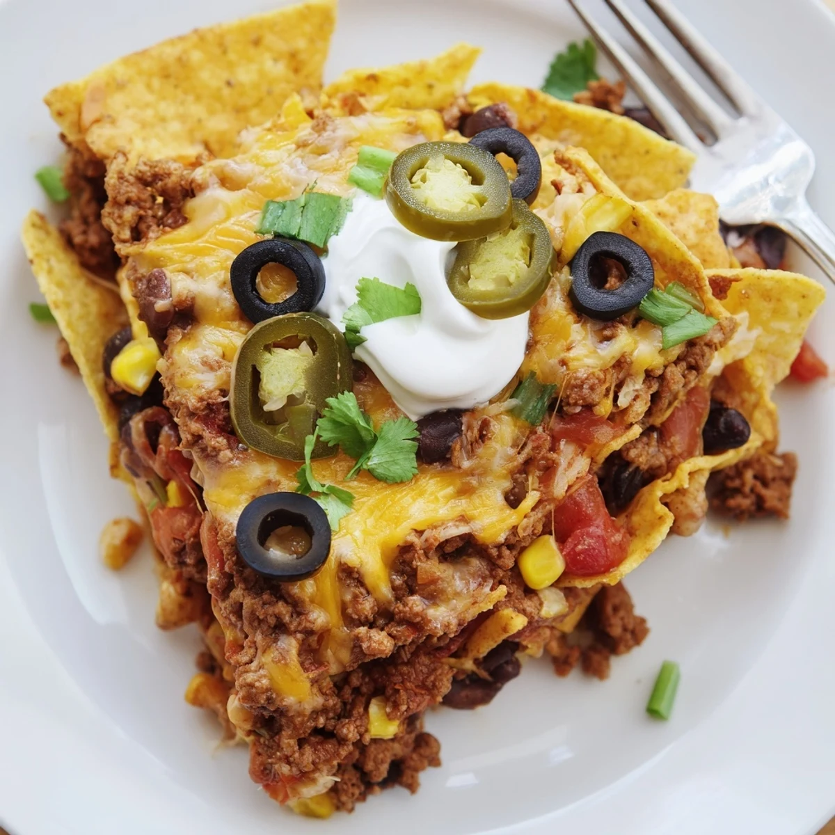 Skillet of melted cheddar, crunchy chips, jalapeños — Cheesy Nacho Casserole