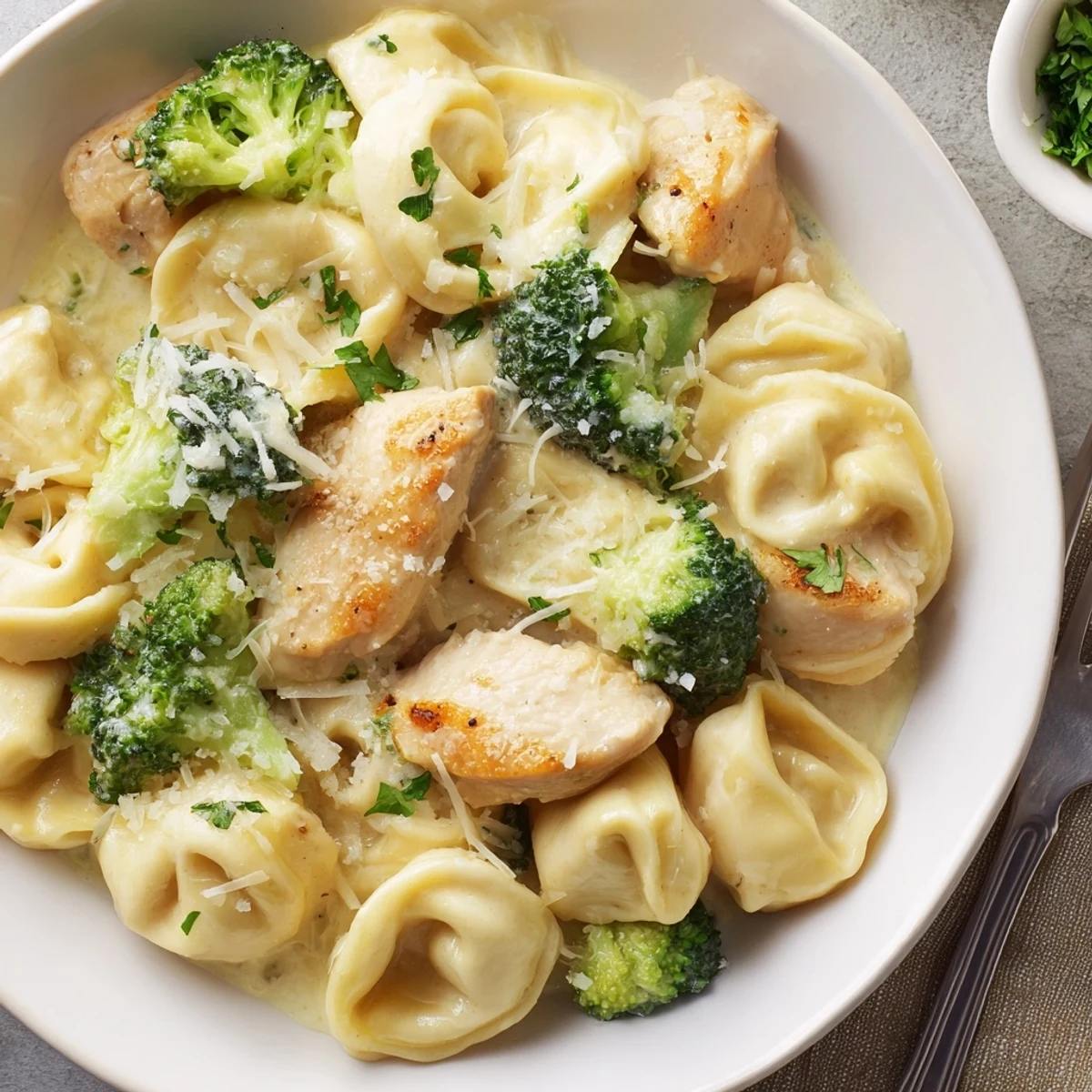 Creamy Garlic Parmesan Tortellini Chicken Broccoli Recipe with golden sear and rising steam