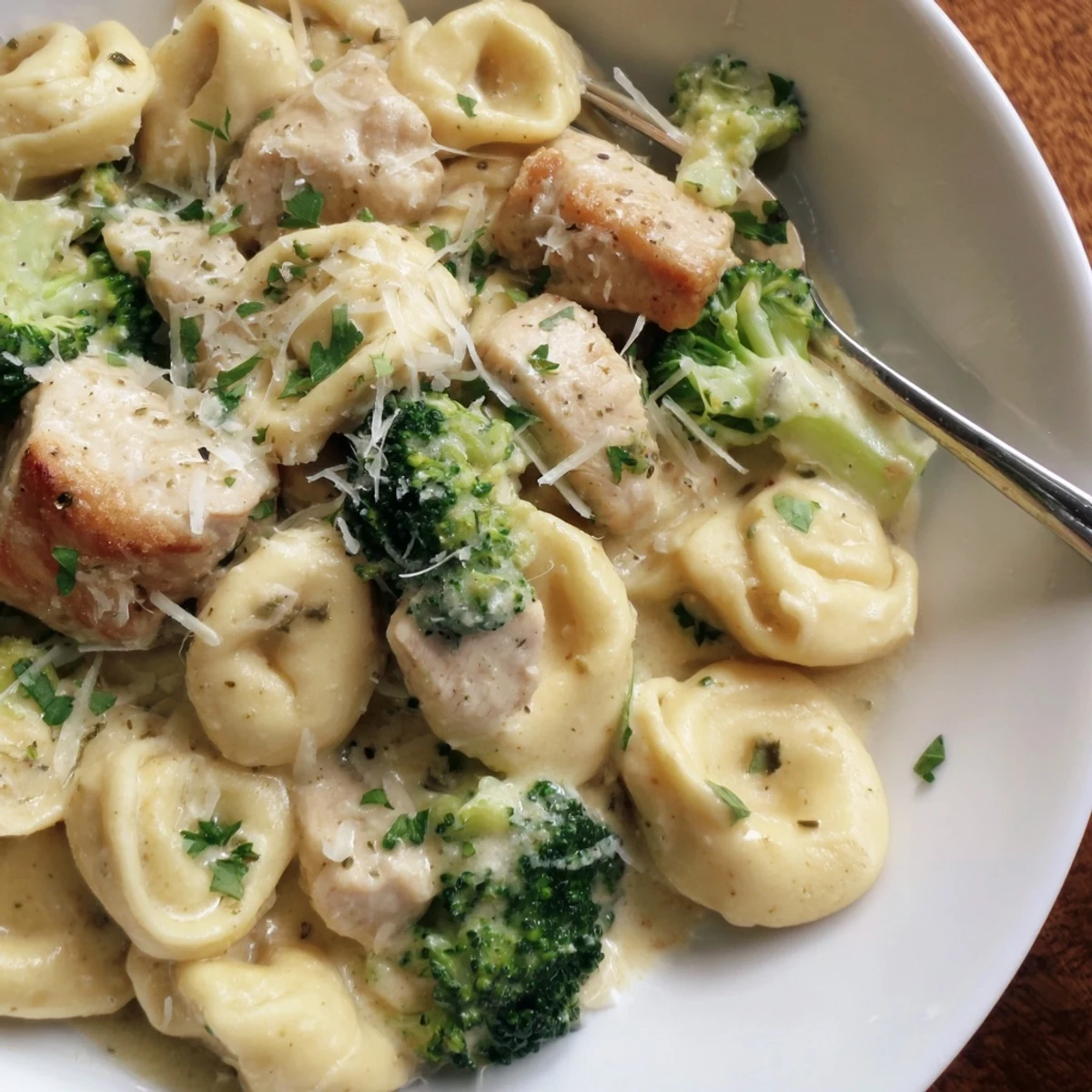Saucy skillet of browned chicken and broccoli — Creamy Garlic Parmesan Tortellini Chicken Broccoli Recipe