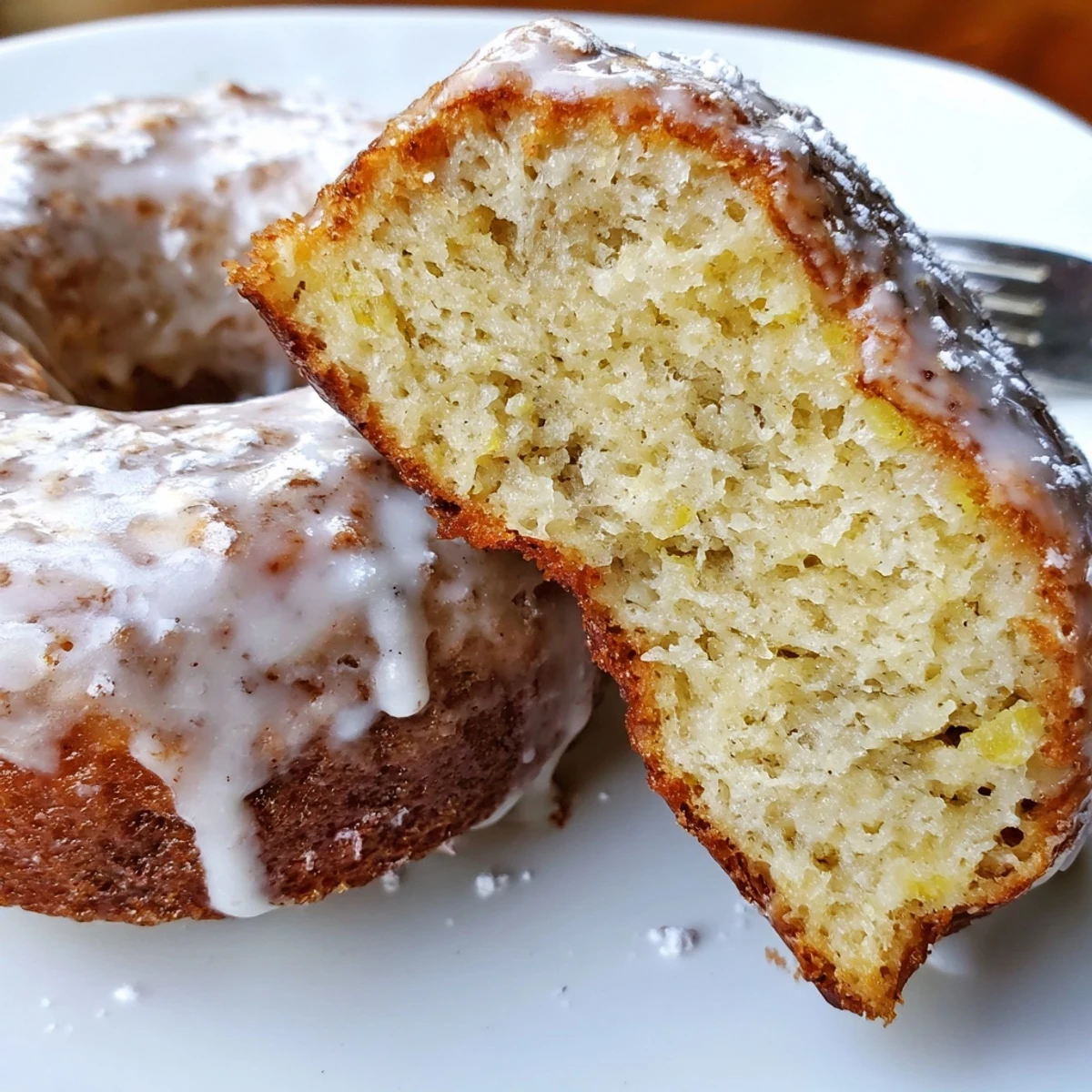 Warm Banana Donuts with glossy vanilla glaze steaming on a wire rack