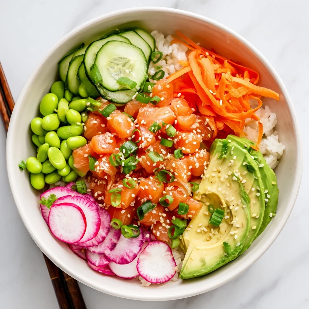 Colorful salmon and avocado poke bowl with fresh vegetables over seasoned rice