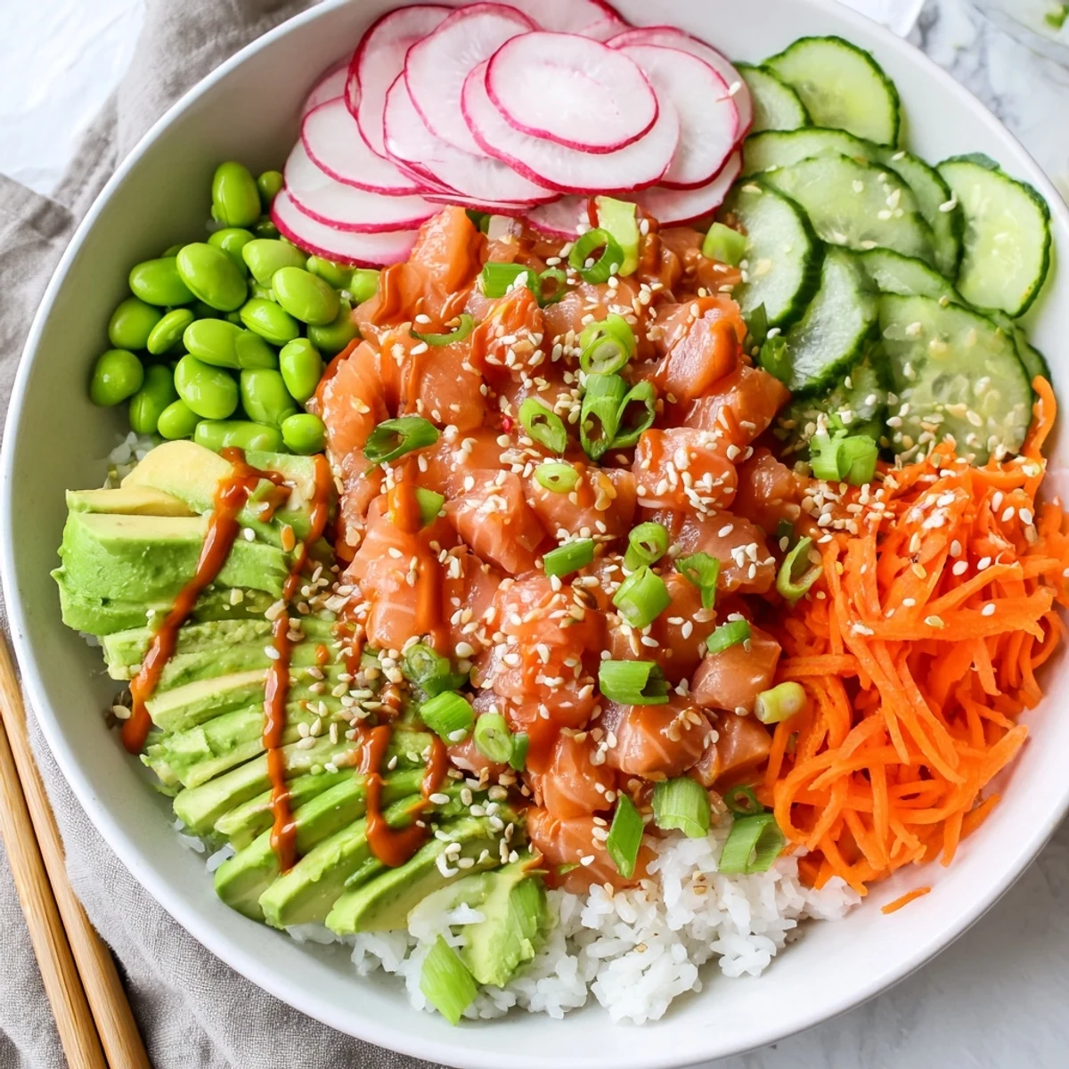 Glowing bowl of marinated salmon and creamy avocado served over sushi rice with rainbow vegetables