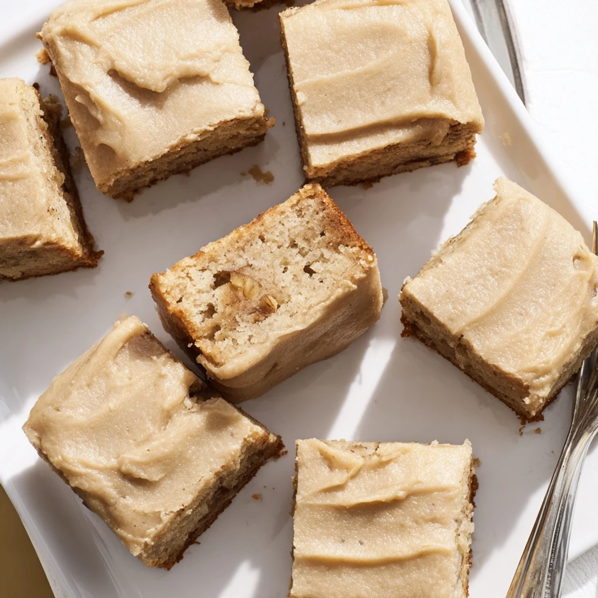Fudgy banana bread brownies square with creamy browned butter glaze drizzle