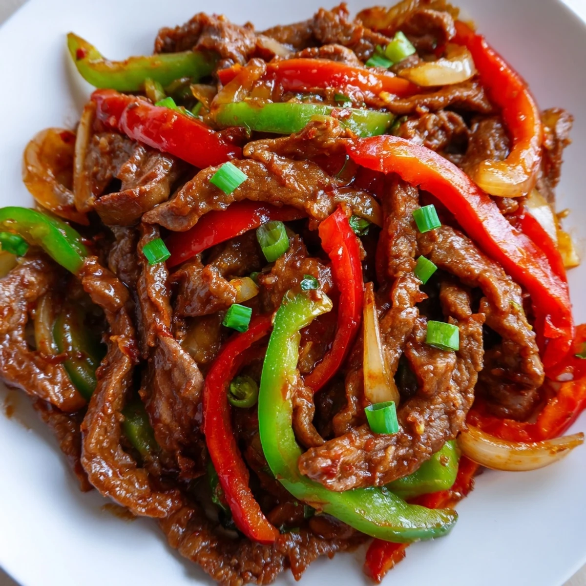 Close-up of spicy beef stir fry with chili garlic featuring crisp vegetables and tender beef slices