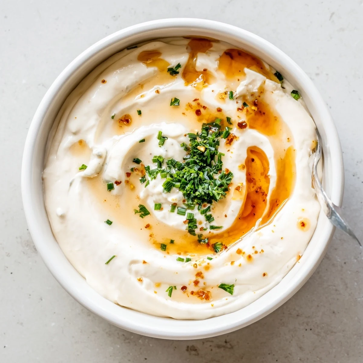 Creamy Hot Honey Ranch Dip drizzled with honey, served with colorful veggies.
