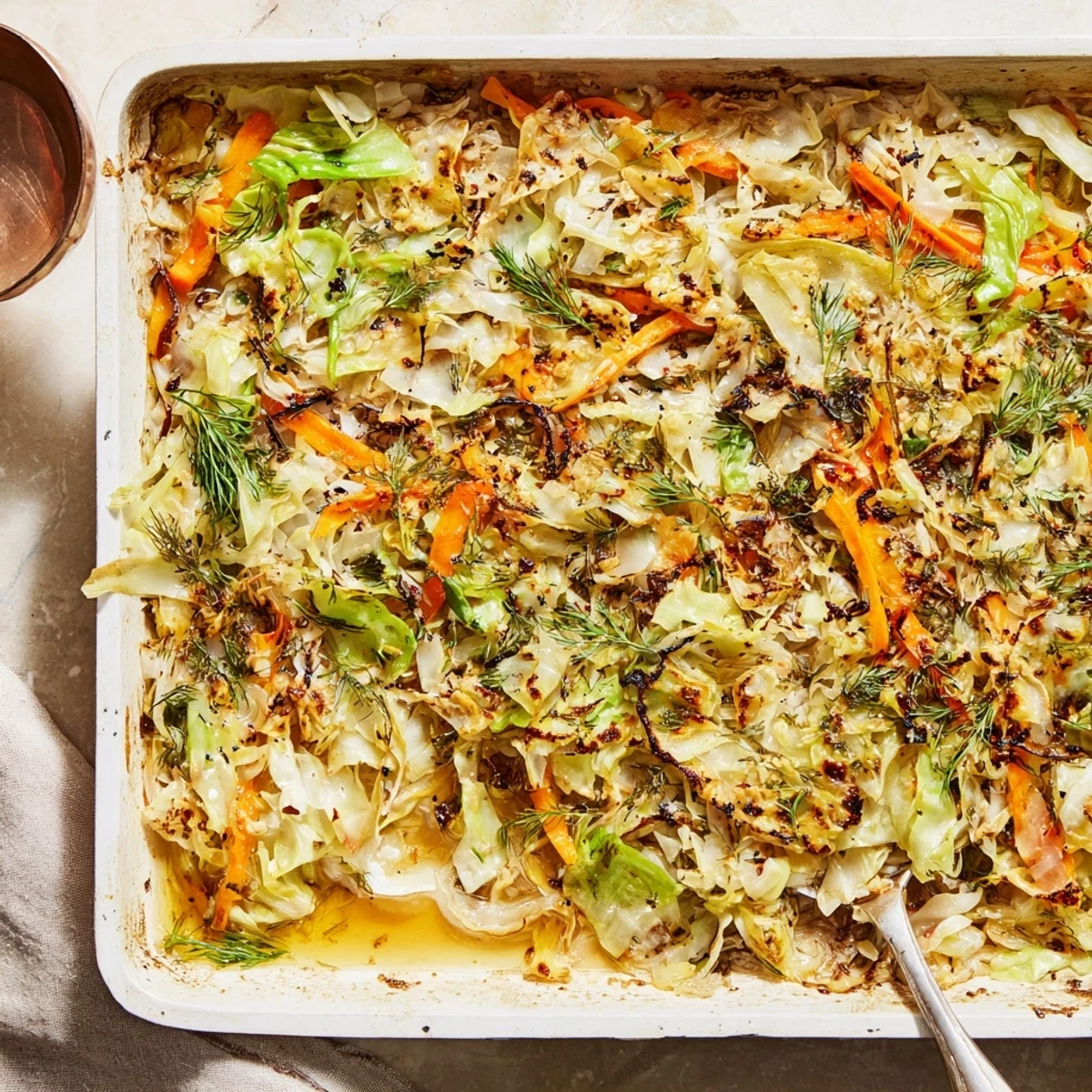 Comforting vegetarian slow roasted cabbage and sauerkraut casserole served warm with dollops of creamy sour cream on top