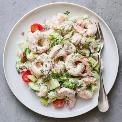 Pink shrimp salad recipe in a bowl with crisp celery and creamy lemon dressing