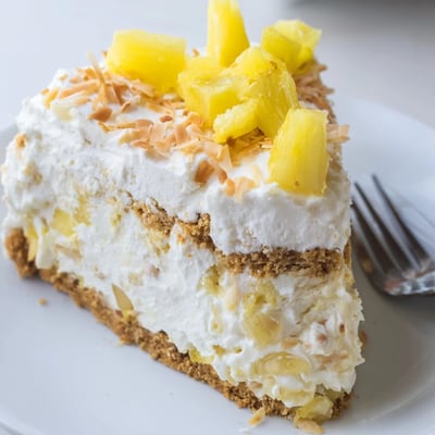 Golden graham cracker crust visible in this No Bake Pineapple Coconut Cream Cake